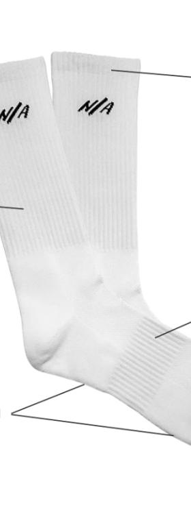White Necessary Anywhere socks with details and features of the socks listed out