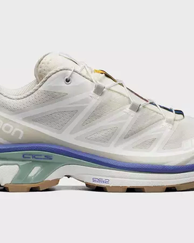 A white pair of Salomon Xt-6 shoes with purple and green details