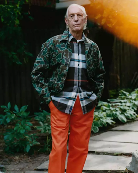 An older man wearing a camo print Noah jacket and orange pants
