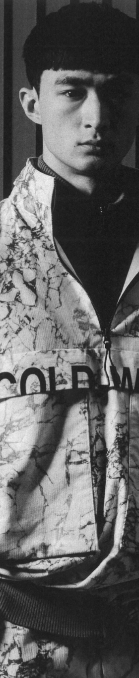 A man wearing a camo-styled A-COLD-WALL jacket with matching pants and a black fleece underneath