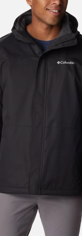 A man wearing a black Columbia winter jacket and dark grey pants