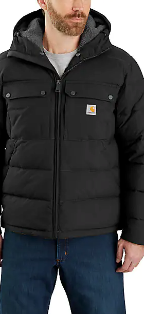 A man wearing a heavy-duty Carhartt black jacket and blue jeans