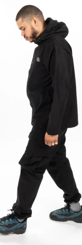 A man wearing an all-black Poler outfit feating a winter jacket and pants