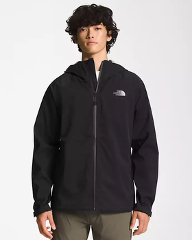 A man wearing a black North Face winter jacket and green pants