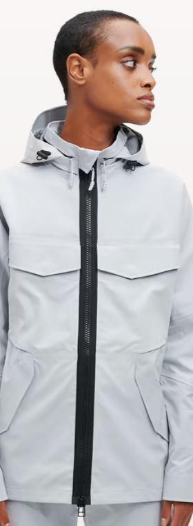 A woman wearing a light grey futuristic, contemporary On-Running Jacket