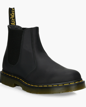 A black pair of slip-on Dr. Martens boots on a white background