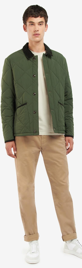 A man wearing a Barbour green jacket, a cream t-shirt and brown pants