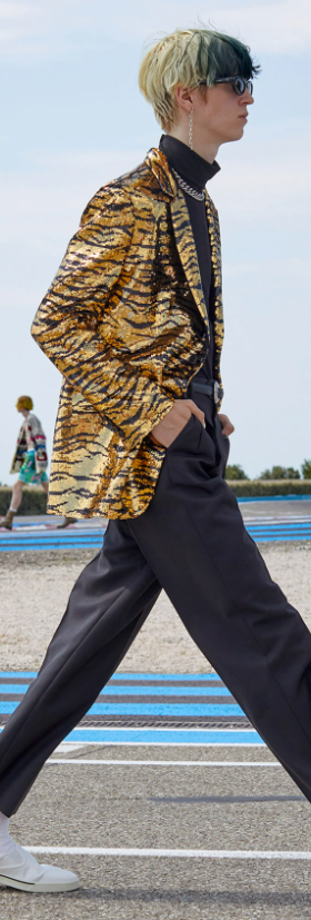 A man wearing a Celine cheetah print jacket and black pants