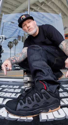 A man close up of a man wearing Osiris skateshoes in black and red