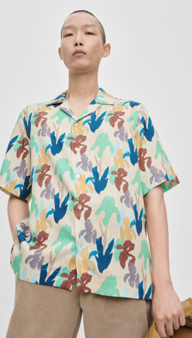 A man wearing a colorful print Paul Smith short-sleeve button up