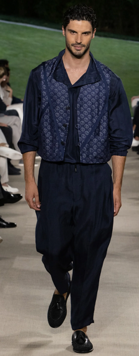 A man wearing a Giorgio Armani outfit walking a runway