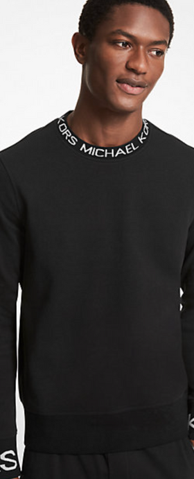 A man wearing a Michael Kors branded black long-sleeve