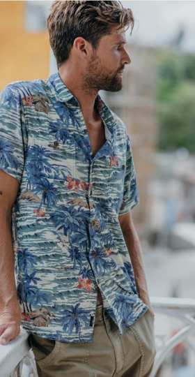 A man wearing a blue Hawaiian button up from Faherty