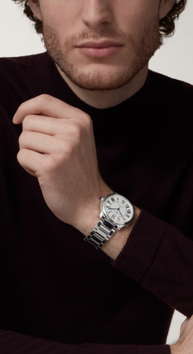 A man wearing a Cartier watch in silver