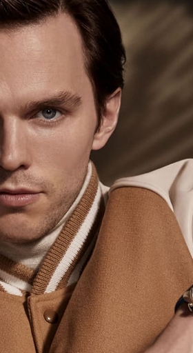 A man wearing a Jaeger-LeCoultre watch and a brown jacket