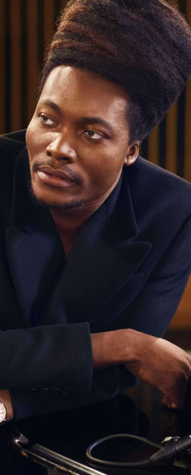 A man wearing a Vacheron Constantin watch and a black shirt