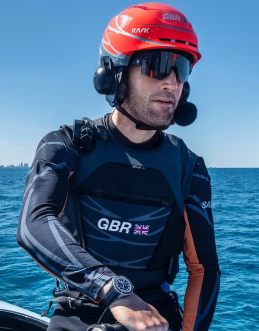A man wearing a Rolex watch out on the water