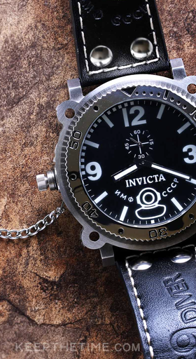 A close-up of an Invicta black watch
