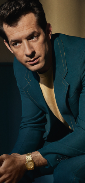 A man wearing a Audemars Piguet watch and a blue suit