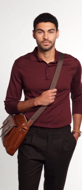 A man wearing a Fossil jacket and a rouge long-sleeve