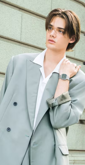 A man wearing a CASIO silver watch and a grey suit