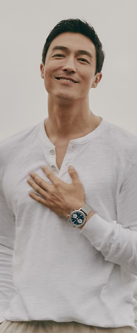 A man wearing a Hamilton watch and a white long-sleeve