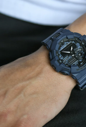 A man wearing a G-SHOCK watch in dark grey