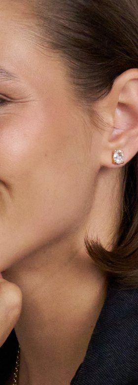 A woman wearing Stella & Dot inheritance oval studs earrings