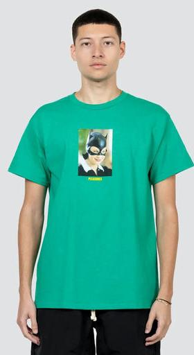 A man wearing a Pleasures green catwoman t-shirt